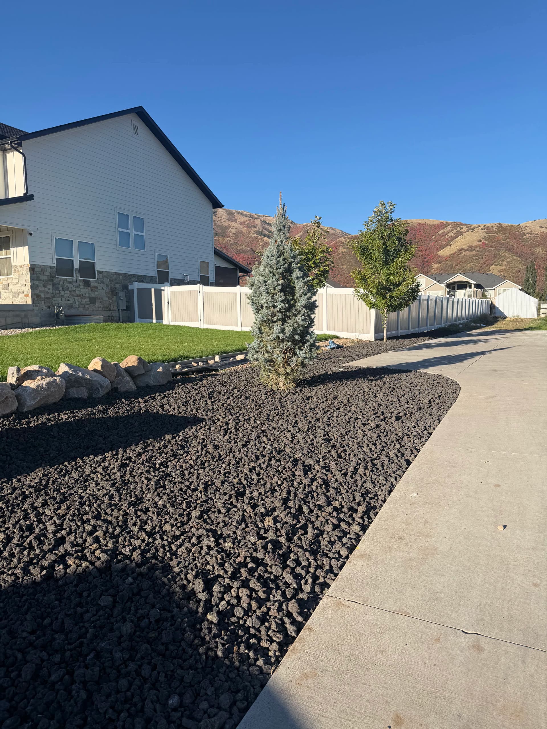 Side Yard Rock Landscaping and Rubber Mulch Play Area Cleanup image
