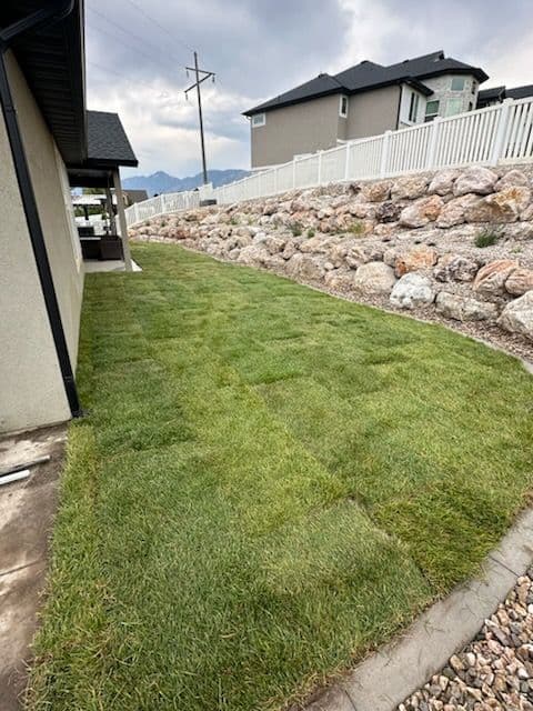 Backyard Transformation with Fresh Sod and Retaining Walls image